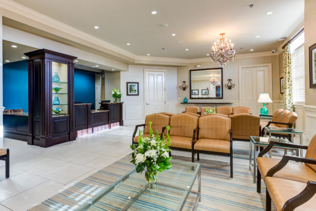 Barrington location waiting area, chairs, desk, chandelier